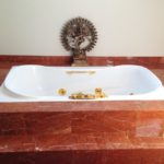 orange marble sunken tub with steps installed by vincent provenzano